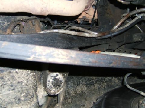 1978 Ford Bronco - Close-up of a vehicle's undercarriage, focusing on suspension and exhaust systems.