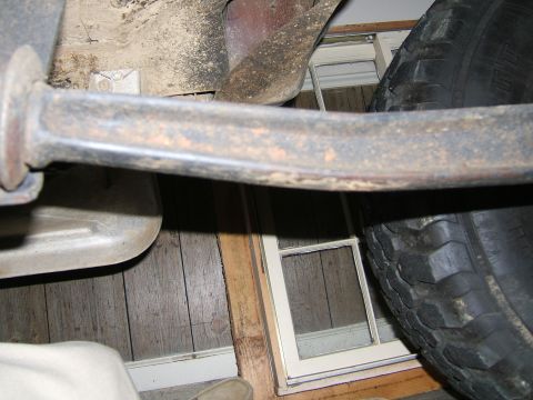 1978 Ford Bronco - A close-up view of a vehicle's undercarriage, showing mechanical parts and a tire.