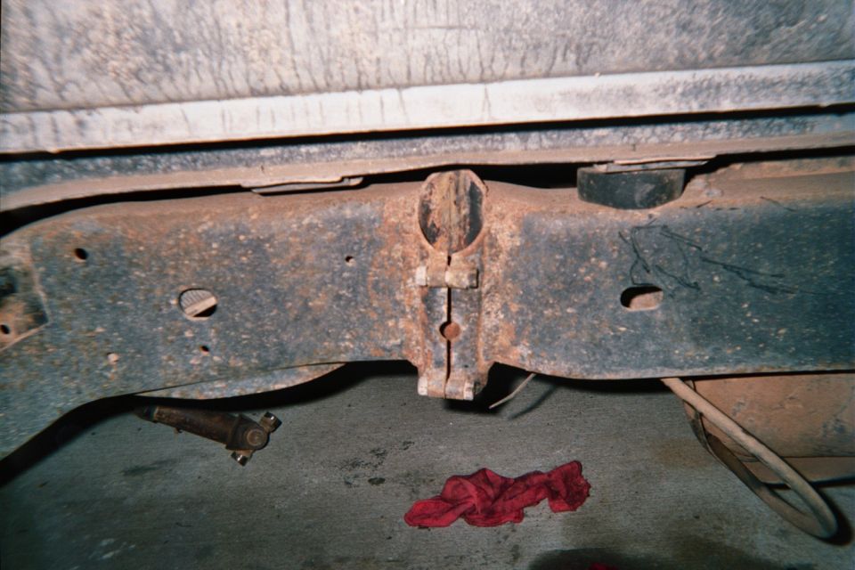 Rusty vehicle crossmember frame seen from underneath