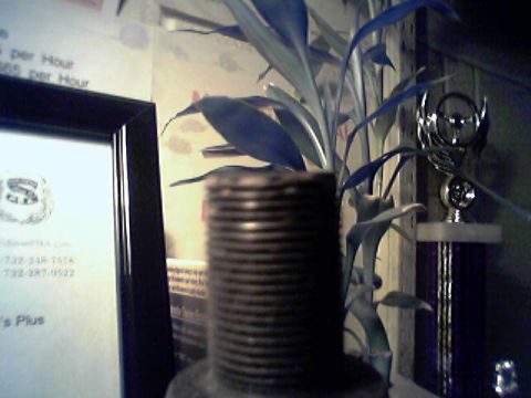1994 Ford Bronco - A trophy and a plant are visible in front of a framed document with text.