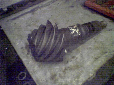 1994 Ford Bronco - A differential gear, likely from a vehicle's drivetrain, is shown on a surface.