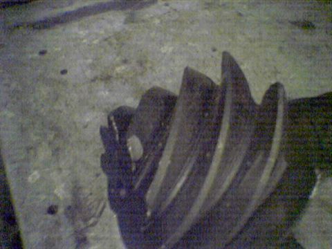 1994 Ford Bronco - A close-up view of a differential gear, showing its intricate teeth and metallic texture.