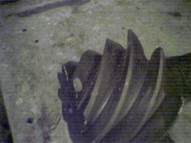 Close-up of a metal gear with teeth, likely from a vehicle's differential