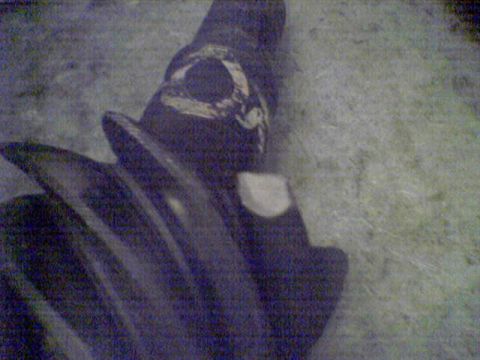1994 Ford Bronco - A close-up view of a dark-colored gear with visible wear and tear.