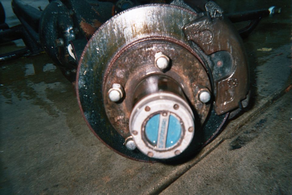 Front disc brake rotor, caliper and locking hub close-up
