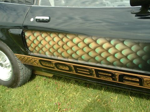 1978 Ford Mustang II - Custom "COBRA" text and scale paint adorn the side of a black car.