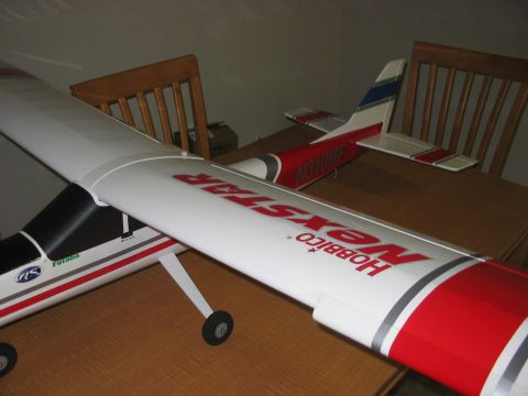 1988 Ford Bronco - A model airplane, identified as a Hobbico NexStar, rests on a table.