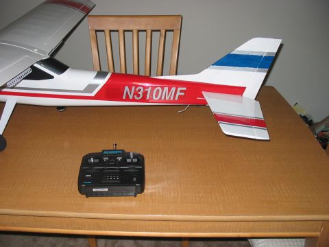 1988 Ford Bronco - A model airplane sits on a table with its remote control.