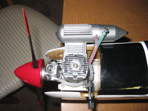 1988 Ford Bronco - Close-up view of a model airplane engine, a red propeller and silver exhaust system.