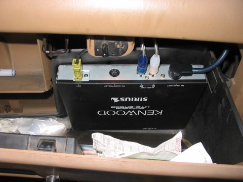 1988 Ford Bronco - A Kenwood Sirius car stereo unit is installed in the glove compartment of a vehicle.