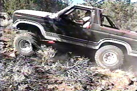 1984 Ford Bronco - This Ford Bronco is navigating a challenging off-road trail.