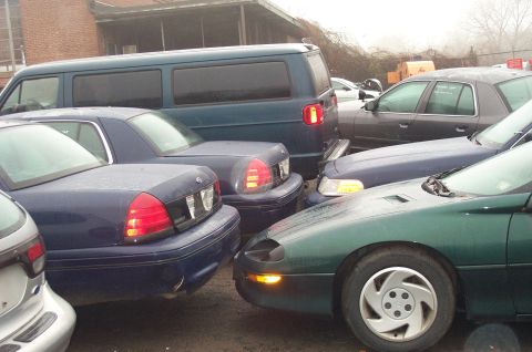 1991 Ford LTD Crown Victoria - A blue 1991 Ford Crown Victoria is parked closely with other vehicles.