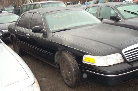 1991 Ford LTD Crown Victoria - Black 1991 Ford Crown Victoria LTD sedan parked outdoors with other vehicles. Text is written on the windshield.