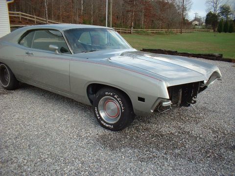 1971 Ford Torino - This silver coupe, likely from the early 1970s, is missing its front grille and bumper components.