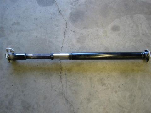 1994 Ford Bronco - A driveshaft is shown against a concrete background, with the Supermotors.net logo visible.