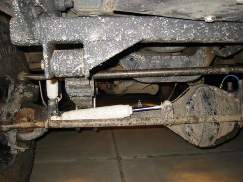 1994 Ford Bronco - The photo shows the undercarriage of a vehicle, focusing on the suspension and drivetrain components.