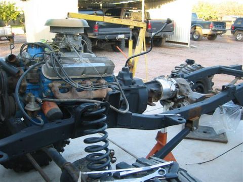 1994 Ford Bronco - Engine and transmission assembly for a vehicle, undergoing testing or fitting.