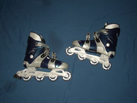 1987 Volkswagen Golf - A pair of blue and silver inline skates are displayed on a blue surface.