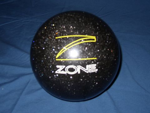 1987 Volkswagen Golf - A black bowling ball with a glitter finish and 'ZONE' branding is displayed on a blue surface.