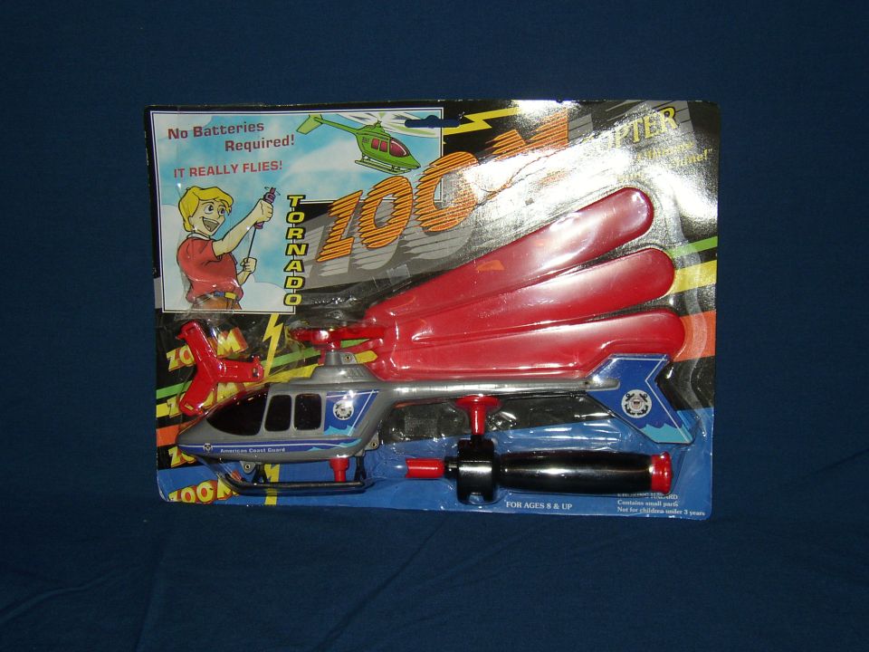 Toy helicopter in packaging with red blades and blue accents