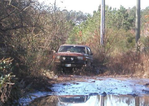 1988 Ford Bronco - Ford Bronco stuck in mud on a wooded trail.
