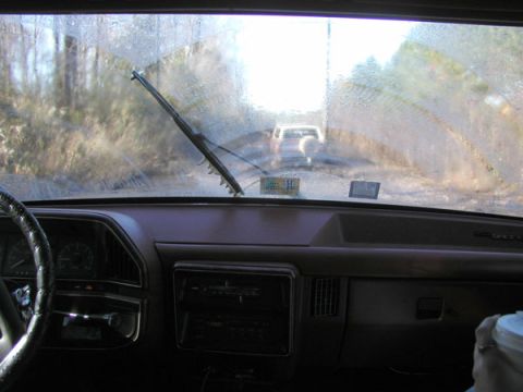 1988 Ford Bronco - View from inside a 1988 Ford Bronco, looking out at another vehicle on a dirt road.