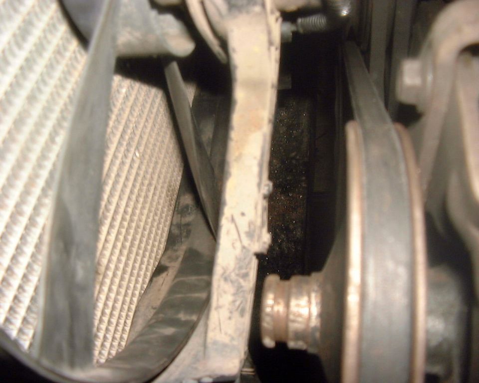 Engine bay view of radiator and belt system