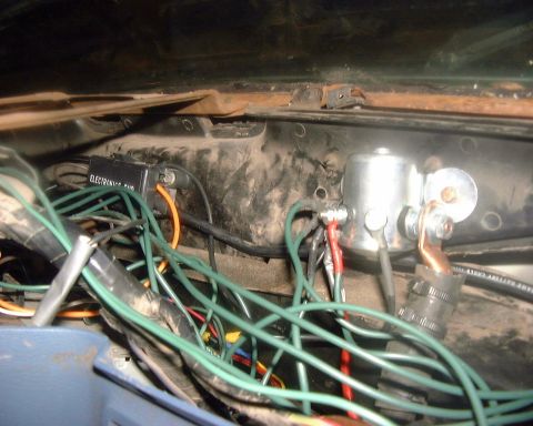 1985 Ford F-150 - A complex network of wires and electrical components are visible inside the vehicle's dashboard area.