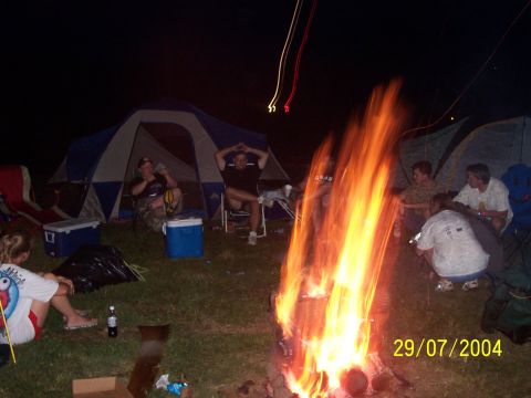 1979 Ford F-150 - Campfire scene with tents and people gathered at night, dated 29/07/2004.