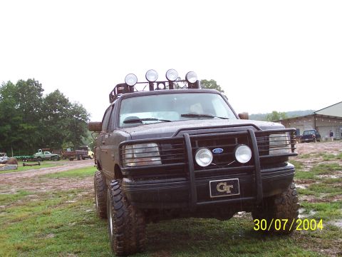 1979 Ford F-150 - Modified Ford truck with bull bar and roof lights parked in a muddy field. Date stamp is 30/07/2004.