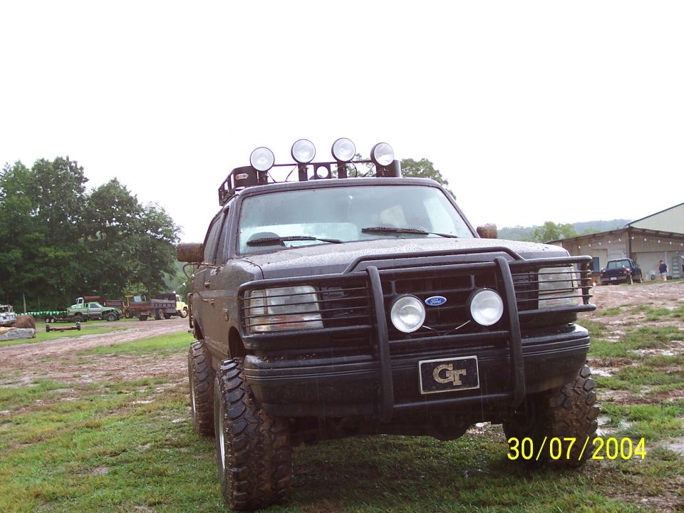 Modified Ford truck with bull bar, roof lights, and large tires. Date stamp reads 30/07/2004