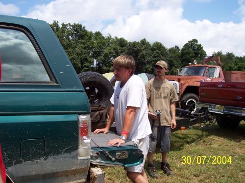 1979 Ford F-150 - Two men stand near a 1979 Ford F-150 pickup truck and a green SUV on a sunny day.