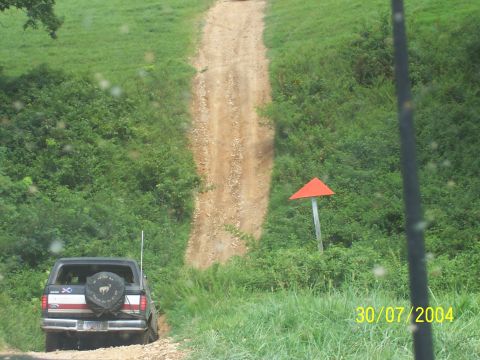 1979 Ford F-150 - A black Ford Bronco navigates a steep dirt path on a sunny day.
