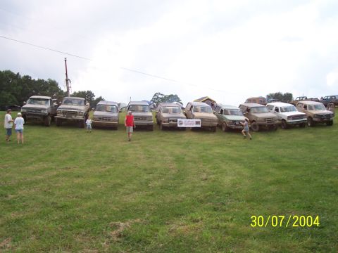 1979 Ford F-150 - A collection of trucks and SUVs are lined up in a field, with a date stamp indicating July 30, 2004.