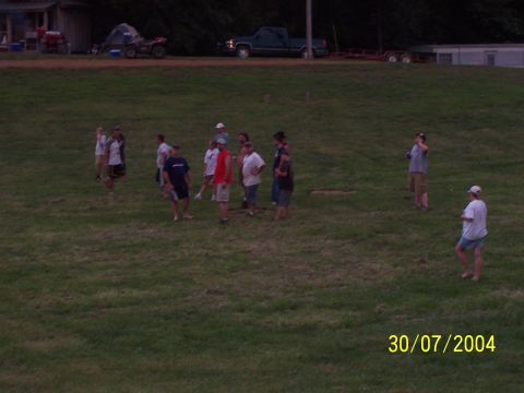 1979 Ford F-150 - People are standing in a field on a sunny day, with a truck and ATV visible in the distance.