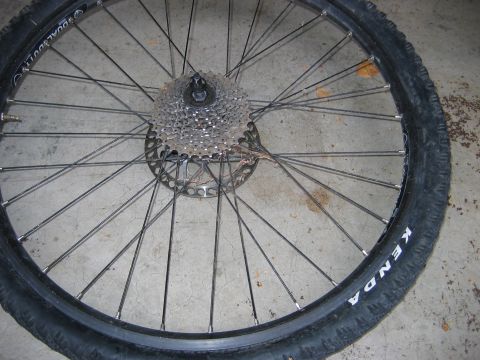 1995 Ford Bronco - A bicycle wheel with a cassette and disc brake rotor is shown on a concrete surface.