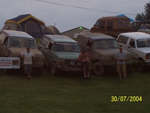 1979 Ford F-150 - Several Ford Broncos and a van are parked on a grassy field with tents in the background.