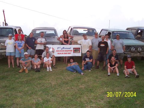 1979 Ford F-150 - A group of people and multiple trucks are gathered for an event, as indicated by the banner and date stamp.