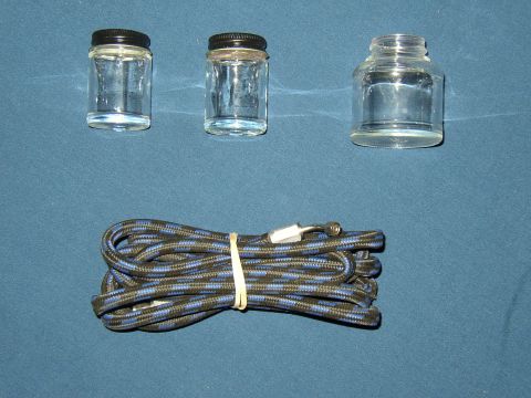 1987 Volkswagen Golf - Airbrush hose and jars shown against a blue background. No vehicle is visible.