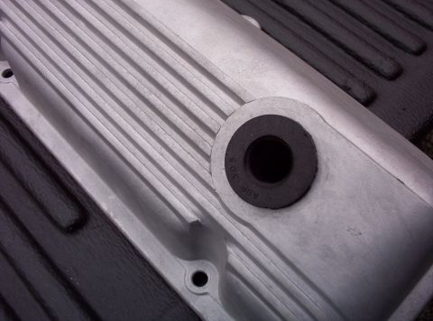 1991 Ford LTD Crown Victoria - Close-up of an aluminum engine valve cover, showing ribbed texture and part number markings.