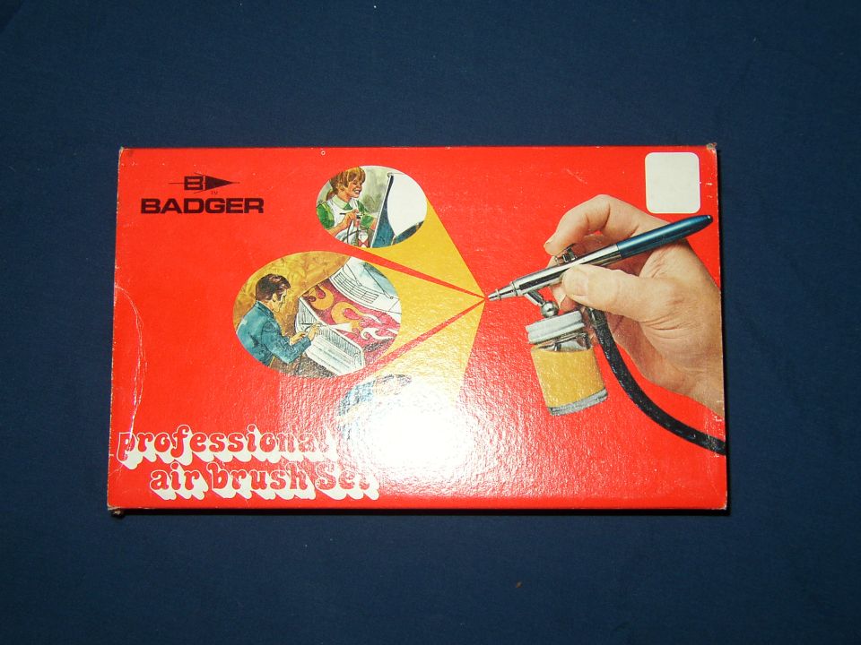 Box for Badger professional air brush set. Shows hand holding airbrush, and illustrations of people using it
