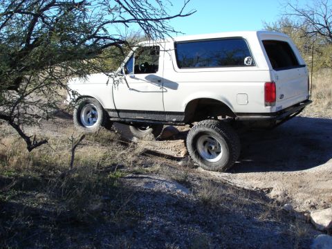 1987 Ford Bronco - This 1987 Ford Bronco navigates a off-road path.
