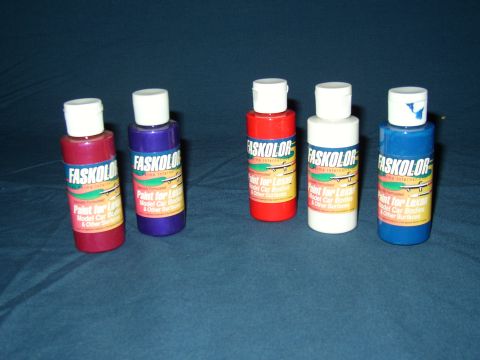 1987 Volkswagen Golf - Collection of Faskolor paints in red, purple, red, white, and blue bottles.
