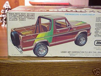 1979 Ford Bronco - Side panel of a worn Lesney AMT model kit box showing artwork of a maroon Ford Bronco converted to a custom pickup, with the rear roof sect…