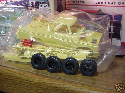 1979 Ford Bronco - A model kit of a pickup truck is shown in its packaging with loose tires.