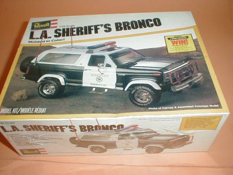1979 Ford Bronco - A sealed Revell 1/25 scale "L.A. Sheriff's Bronco" model kit box photographed at an angle, showing the assembled prototype as a black-and-w…
