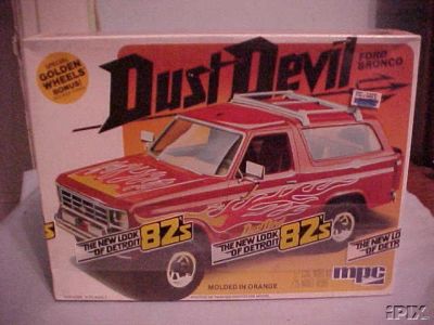 1979 Ford Bronco - Box art for a 1979 Ford Bronco model kit, a red body with flame decals and "Dust Devil" branding.