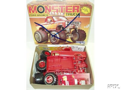 1979 Ford Bronco - A model kit box depicts a monster truck version of a Ford Bronco, with unassembled red plastic parts visible below.
