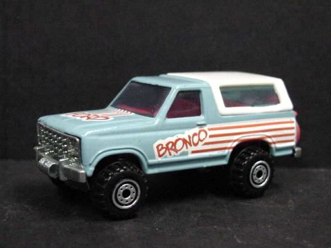 1979 Ford Bronco - A close-up of a toy Ford Bronco with distinctive racing stripes on its side.