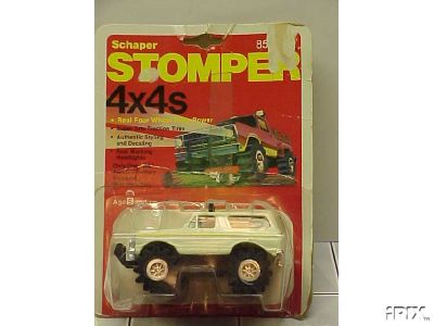 1979 Ford Bronco - A 1979 Ford Bronco toy is displayed in its original packaging, showing its side profile.
